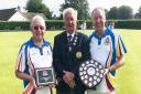 Harpenden president Gordon Burrow (left) and captain Roy Polley receive the rink league trophy from SADBA president Terry Atkinson.