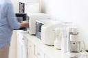 Make sure toasters, kettles and coffee machines have a home that wont block all your workspace, and consider stashing underused tech in other rooms. Picture: iStock/PA