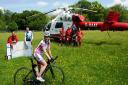 Foreground: Shusanah Pillinger (on her bike)
Middle ground (L-R): Erica Ley, Critical Care Paramedic/RAAM Crew Member and Phil Magnus, RAAM Crew Mechanic
Background: Herts Air Ambulance Air Crew