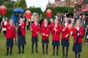 Children prepare to launch balloons to celebrate the opening