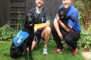 Kevin Hayes is in the black top with Guide Dog puppy Oakley (12 months old) and his friend David Rawlings is in the blue top with Guide Dog puppy Marble (4 months old)