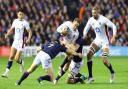 Nick Isiekwe (right) looks on as Max Malins is tackled by Hamish Watson during England's Six Nations defeat to Scotland.