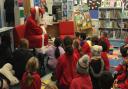 Father Christmas handed out gifts and read a story to the children.