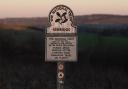 Sunset: A National Trust marker bearing the title \