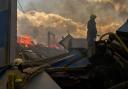 Firefighters at a partially destroyed warehouse after a Russian drone attack in Brovary on the outskirts of Kyiv, Ukraine (Francisco Seco/AP)