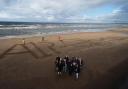 Members of an anti-data centre campaign group lay out a giant anti-AI message on the beach on the flightpath into Prestwick Airport (Andrew Milligan/PA)