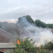 Smoke could be seen rising over nearby homes and gardens.