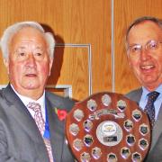 Harpenden Bowling Club's men's captain Roy Polley (right) receives the district league award from SADBA president Terry Atkinson.
