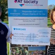 Captains Peter Hart and Cathy Gosling, from Harpenden Golf Club, present the donation to the AT Society.