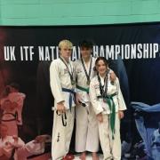 Joel Moss, Dylan Castillo and Zara Fitzgerald on the podium with their gold medals.