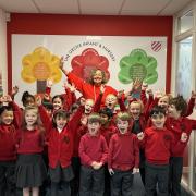 Headteacher Anna Archer with pupils at The Grove Infant and Nursery School, Harpenden.