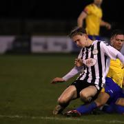 Colney Heath's George Sippetts is tackled by Adam Martin of Berkhamsted. Picture: PETER SHORT