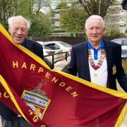 Harpenden president Angus Lowe hands the honour of raising the flag to Barrie Hills. Picture: HBC