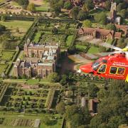 The Essex & Herts Air Ambulance above Hatfield House.