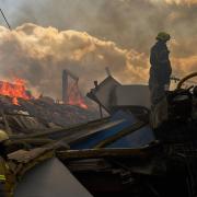 Firefighters at a partially destroyed warehouse after a Russian drone attack in Brovary on the outskirts of Kyiv, Ukraine (Francisco Seco/AP)